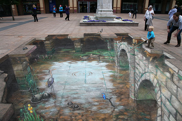 3D Pavement drawing of a lovely river going under a bridge with a heron and a kingfisher