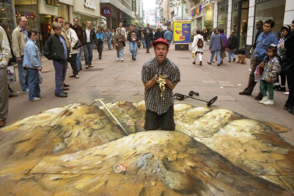 Street 3D chalk illusion of the artist Julian Beever finding a hoard with a metal detector
