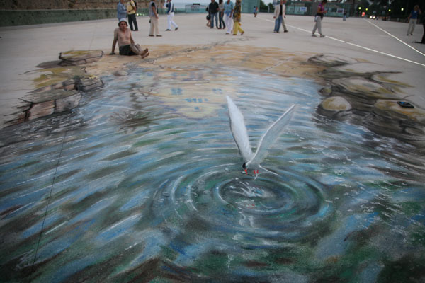 Street drawing of a beach with a seagull catching a fish