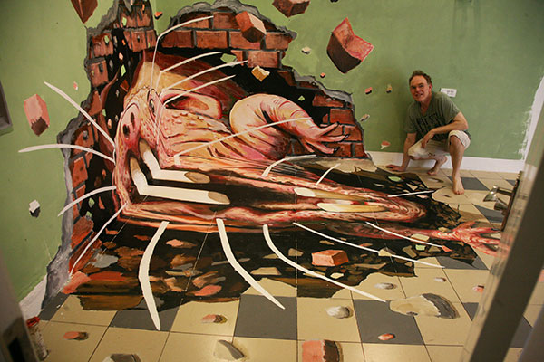 Distorted view of the molerat painting with the artist Julian Beever posing next to it
