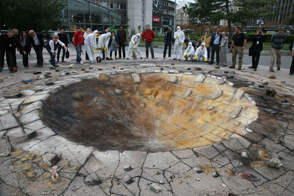 Chalk pavement drawing of a giant hole creating the illusion of an explosion.