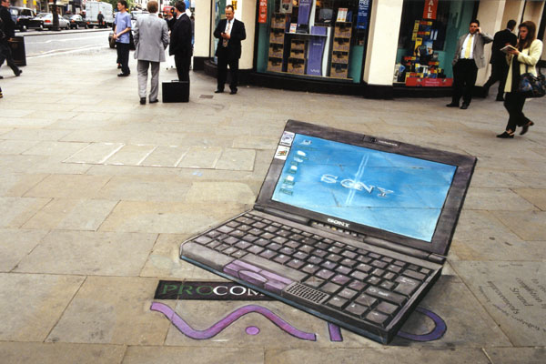 3D chalk illusion of a giant portable computer drawn on the pavement