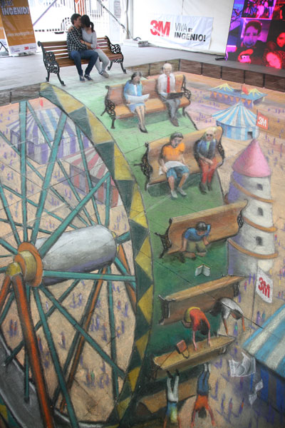 3D street drawing of a big wheel and people falling off it